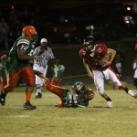 NFC Clint Trickett #16  trying avoid FAMU DL Ian Howard #50