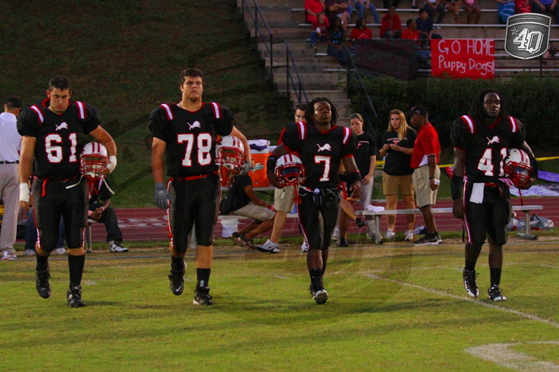 The Lions walk to the field for the coin toss.