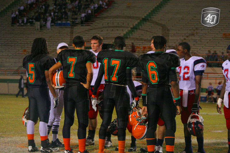 Baby Rattler and War Eagle team captians meet for the coin toss.