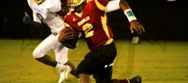 Florida High RB #2 K. Lewis looks for extra yards while Rickards LB #8 B. Denmark closes in for a tackle
